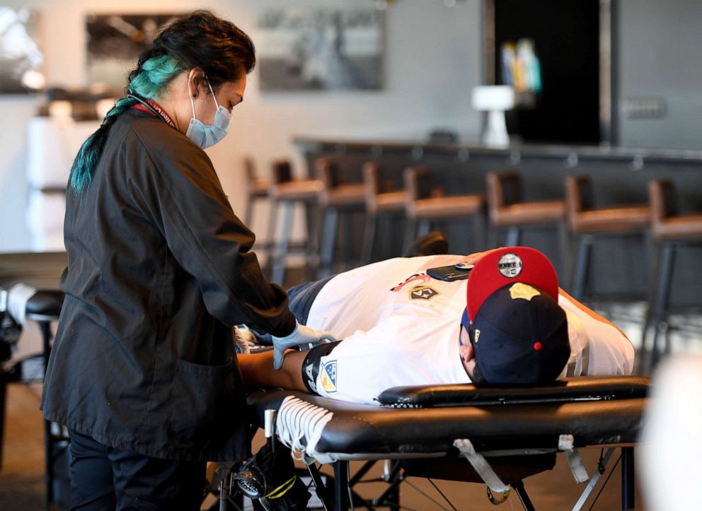 PHOTO: Edith B. Fernandez draws blood from Luis Fregoso inside the Stadium club at Dignity Health Sports Park in Carson, Calif, May 21, 2020.