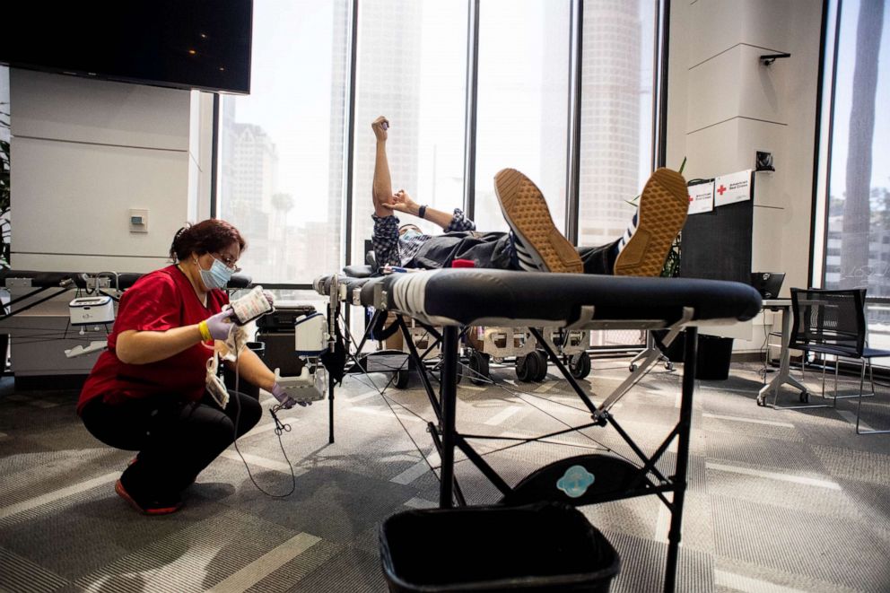 PHOTO: A phlebotomist collects blood from a nurse during a Red Cross blood drive with L.A. Care Health Plan in Los Angeles, March 23, 2021.