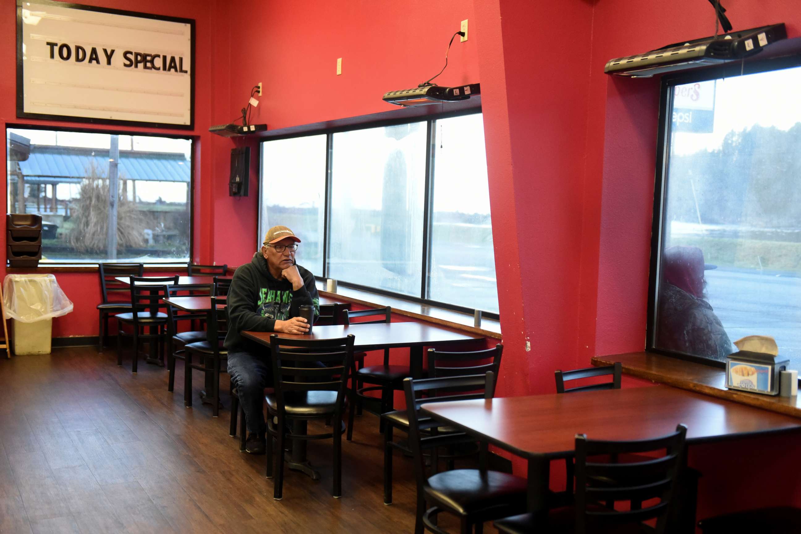 PHOTO: A man sits in the restaurant area of a gas station at Quinault Indian Nation's main village, on the Quinault Indian Reservation in Taholah, Wash. March 6, 2020.