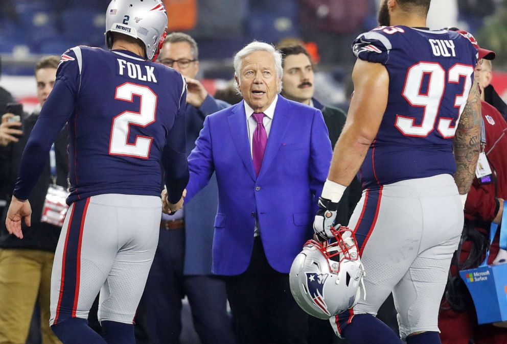 PHOTO: Robert Kraft, owner of the New England Patriots, shakes hands with Nick Folk and Lawrence Guy before the AFC Wild Card Playoff game against the Tennessee Titans on Jan. 04, 2020, in Foxborough, Mass.