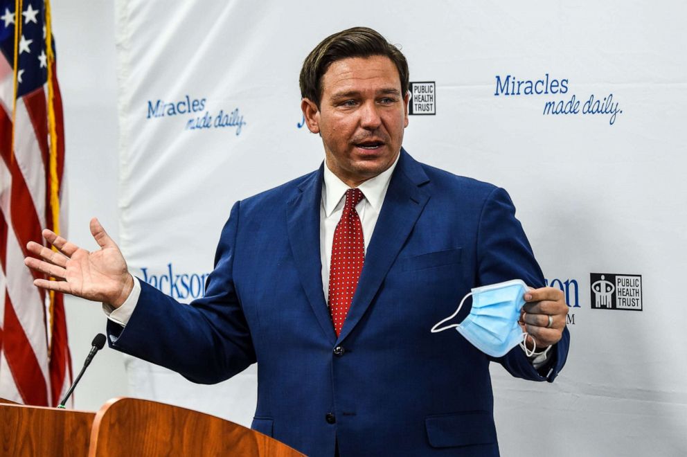 PHOTO: Florida Gov. Ron DeSantis speaks holding his facemask during a press conference to address the rise of coronavirus cases in the state, at Jackson Memorial Hospital in Miami, July 13, 2020.