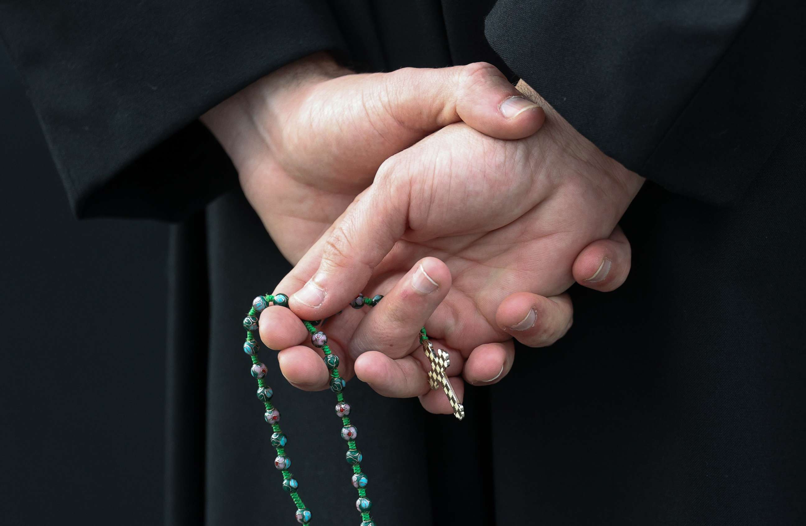 PHOTO: 
Caption *	
Joe McHenry holds a rosary while helping direct traffic at St. Edward the Confessor Catholic Church during drive thru confessions in the church parking lot, March 20, 2020 in Bowie, Md.
