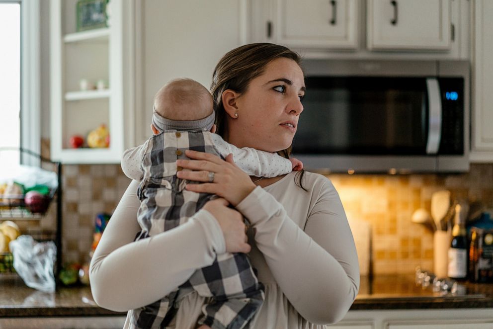 PHOTO: Dr. Caitlyn Berg, a pediatrician, holds her infant daughter Natalie, who contracted RSV (respiratory syncytial virus), at their home in Mount Zion, Ill., Oct. 30, 2022.
