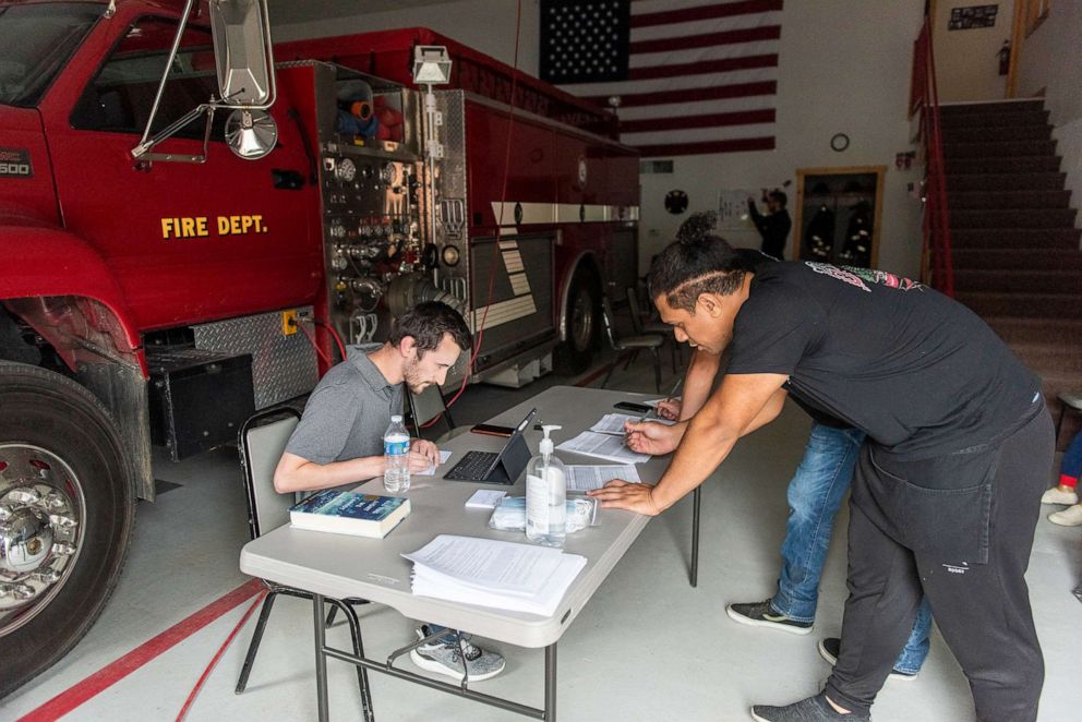 PHOTO: Public Health Department COVID-19 conduct an outreach vaccination clinic at the firehouse in the small town Cooke City, Mont., June 8, 2021.