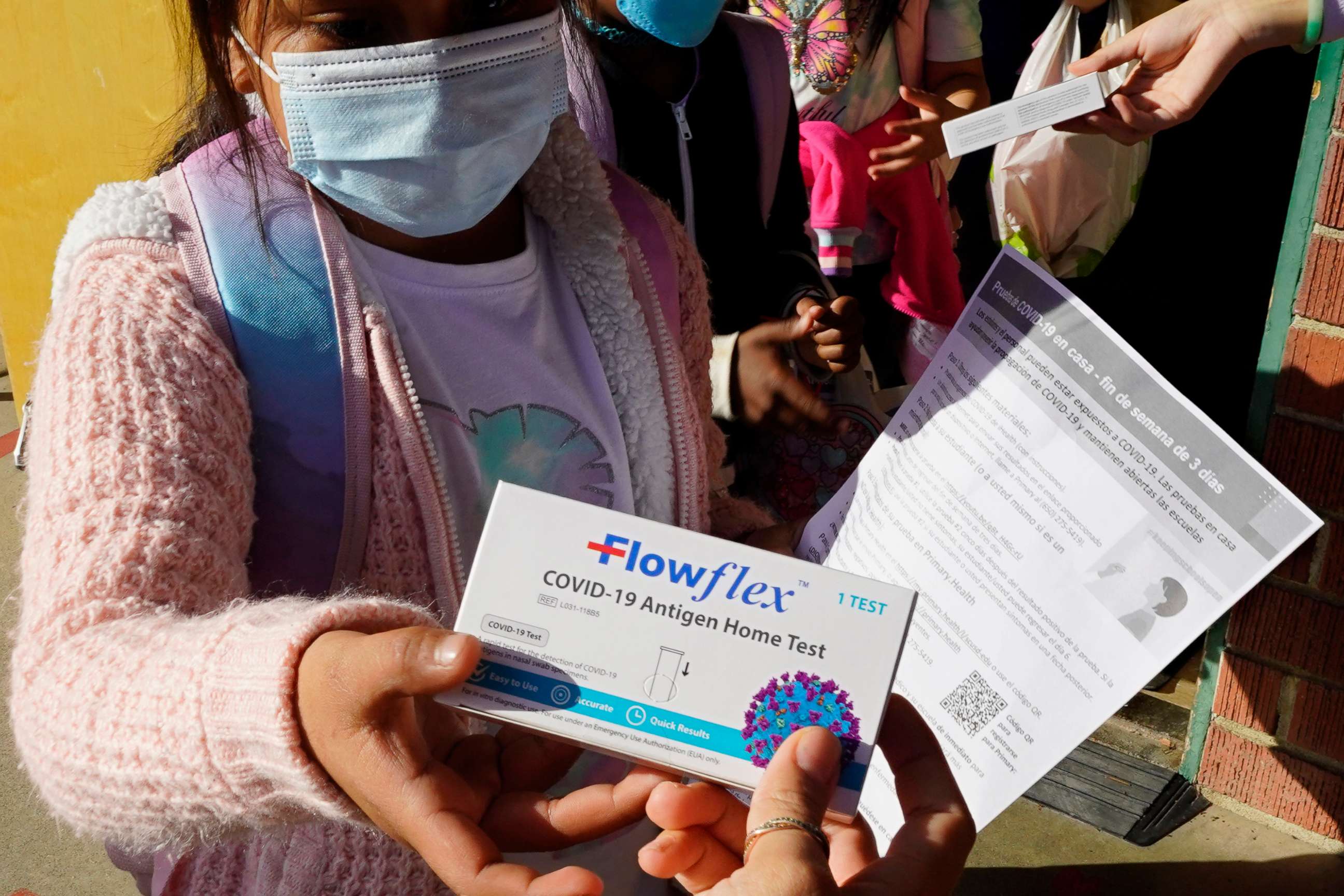 PHOTO: A second grade student is give a at-home COVID-19 test, Feb. 11, 2022, at H.W. Harkness Elementary School in Sacramento, Calif.