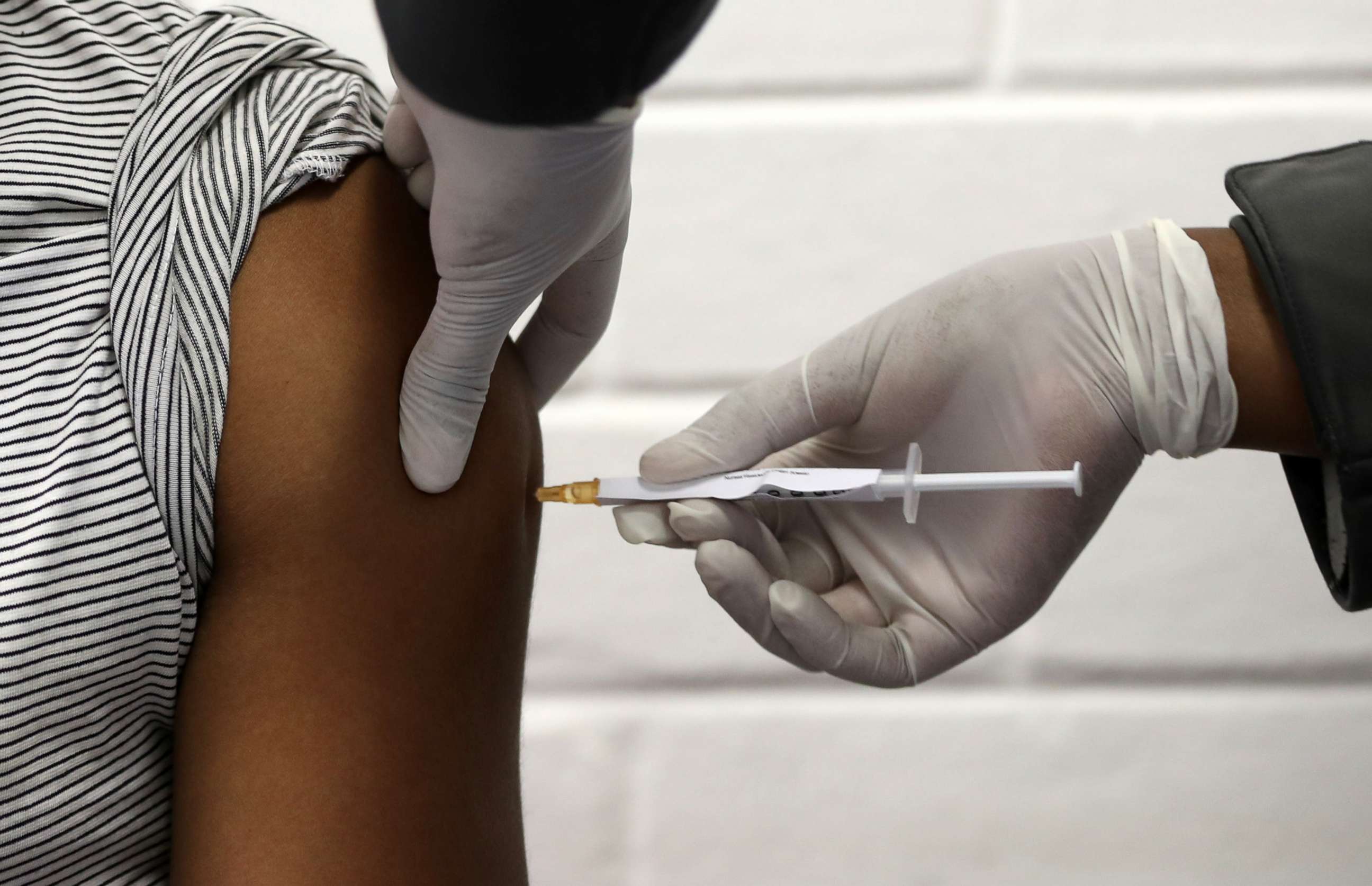PHOTO: One of the first South African vaccine participants gets injected during the clinical trial for a potential vaccine against the COVID-19 at the Baragwanath hospital in Soweto, South Africa, June 24, 2020.