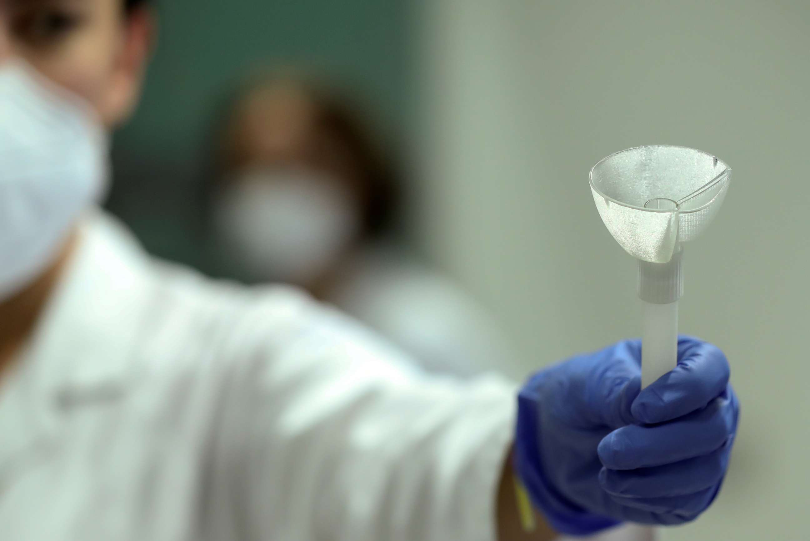 PHOTO: A laboratory worker shows a prototype of a self-test that will use saliva in a rapid COVID-19 test, which could replace more commonly used swabs, at the University of Liege in Belgium Aug. 12, 2020.