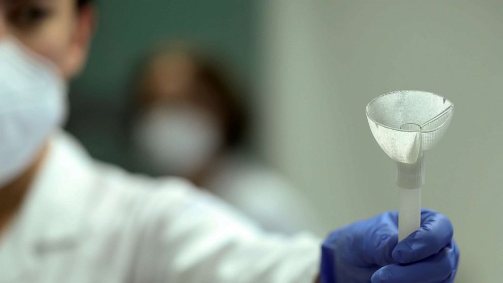 PHOTO: A laboratory worker shows a prototype of a self-test that will use saliva in a rapid COVID-19 test, which could replace more commonly used swabs, at the University of Liege in Belgium Aug. 12, 2020.