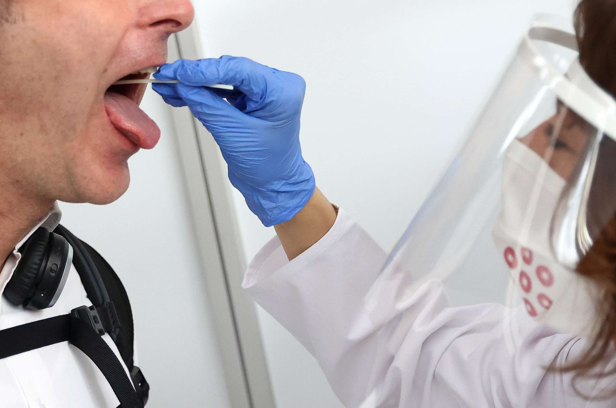 PHOTO: A saliva sample is taken at Germany's first walk-through the coronavirus disease (COVID-19) test center at the airport in Frankfurt, Germany, June 29, 2020.