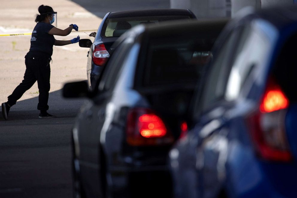 PHOTO: A San Diego County health nurse collects a sample from a patient at a drive-in COVID-19 testing site n San Diego, Calif., June 25, 2020.