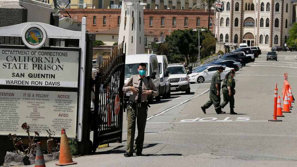 PHOTO: In this July 9, 2020, file photo, a correctional officer stands at the main gate of San Quentin State Prison in San Quentin, Calif.