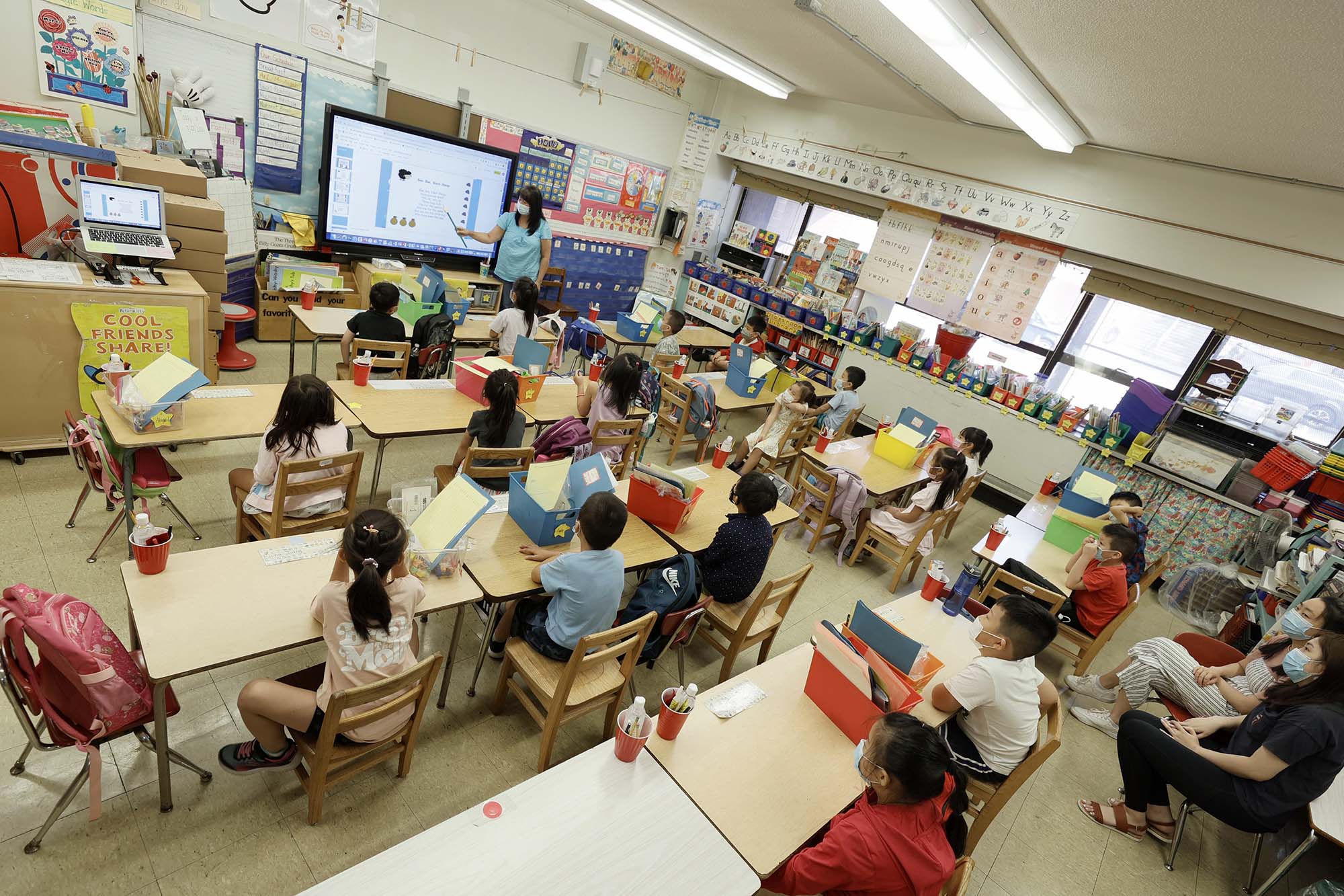 PHOTO: Melissa Moy, a teacher at Yung Wing School P.S. 124, goes over a lesson with in-person summer program students on a monitor in New York, July 22, 2021.