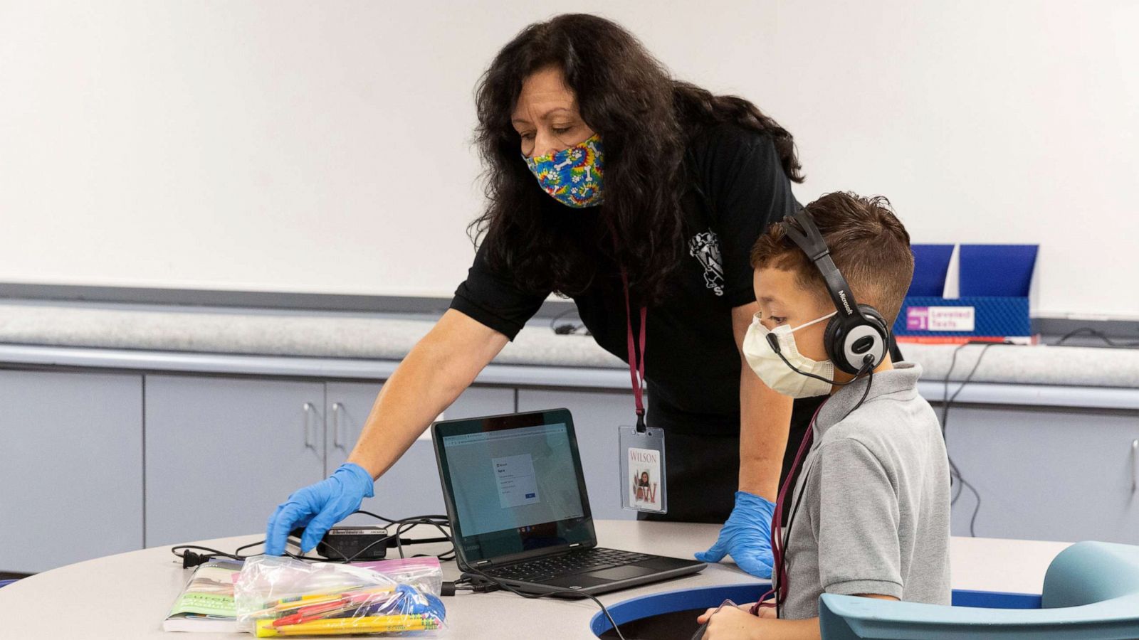 PHOTO:An instructional assistant helps a student as in-person learning resumes with restrictions in place to prevent the spread of coronavirus disease (COVID-19) at Wilson Primary School in Phoenix, Ariz., Aug. 17, 2020.