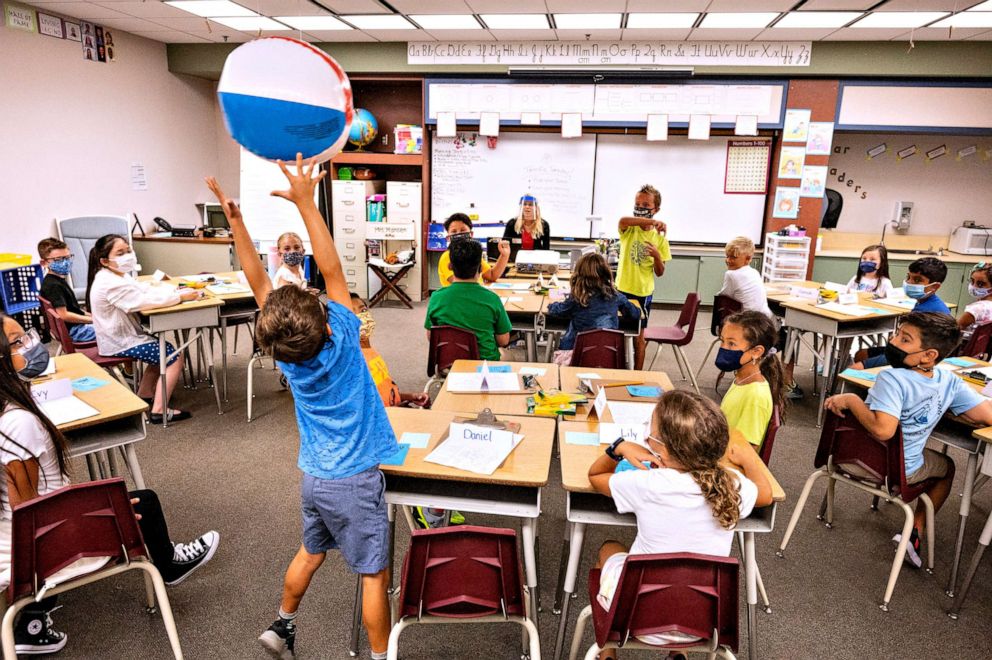 PHOTO: Students pass a beach ball to the next person on the list during roll call on the first day of class at Laguna Niguel Elementary School in Laguna Niguel, Calif. on Aug. 17, 2021.