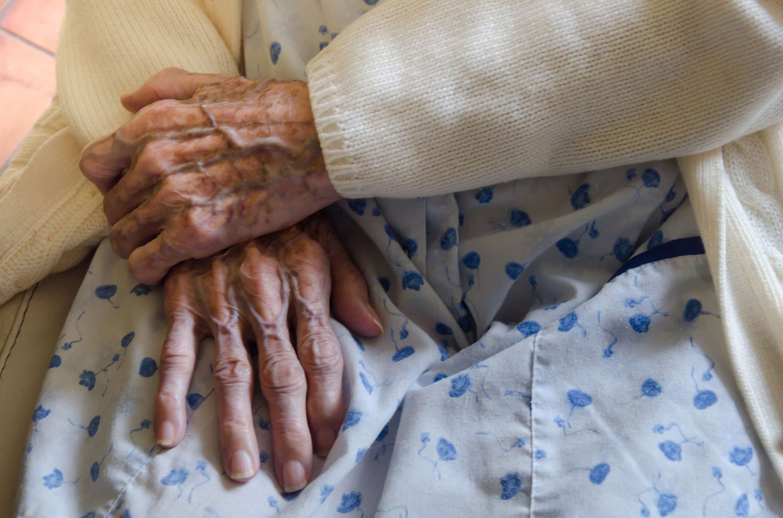 PHOTO: An undated stock photo depicts an elderly woman siting with her hands on her lap.