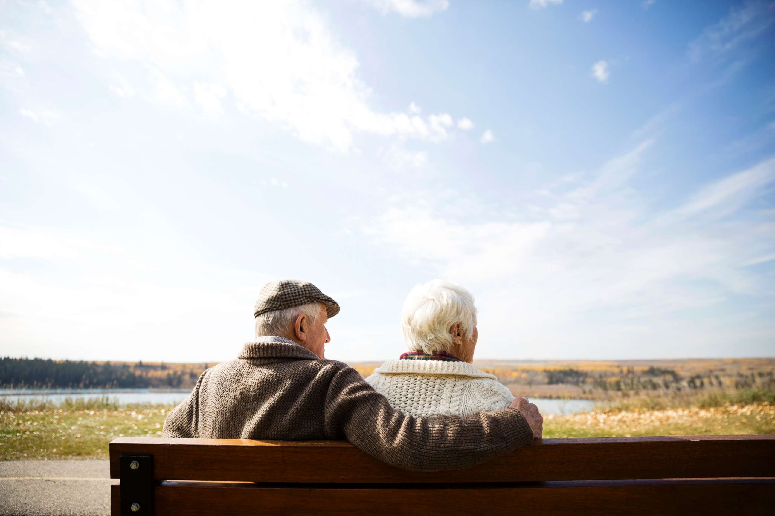PHOTO: A senior couple sit on bench in this stock photo.