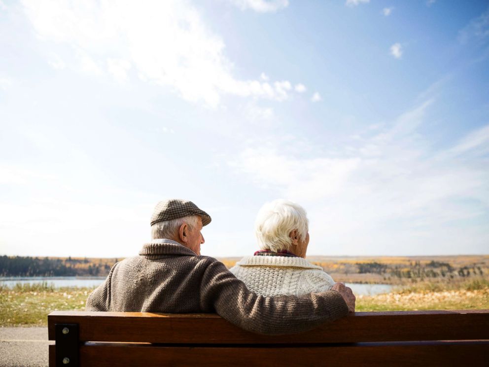 PHOTO: A senior couple sit on bench in this stock photo.