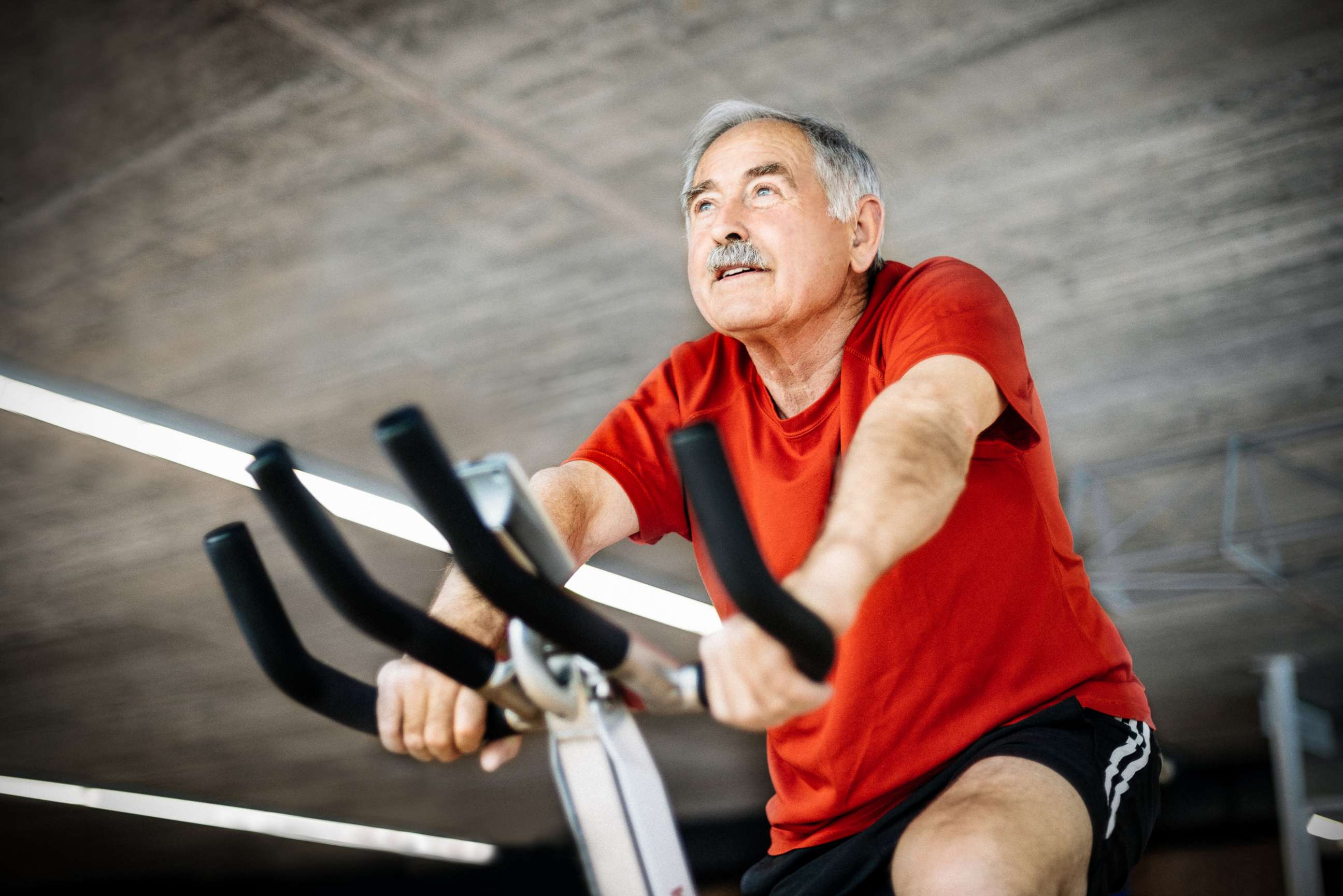 PHOTO: A senior man cycles on a spinning bicycle in a gym in this undated stock photo.