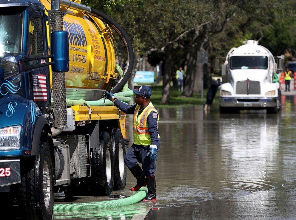 PHOTO: A worker uses a  vacuum truck to suck up sewer water that flooded the area at George English park after a sewer main break broke, Feb. 24, 2020, in Fort Lauderdale, Florida.