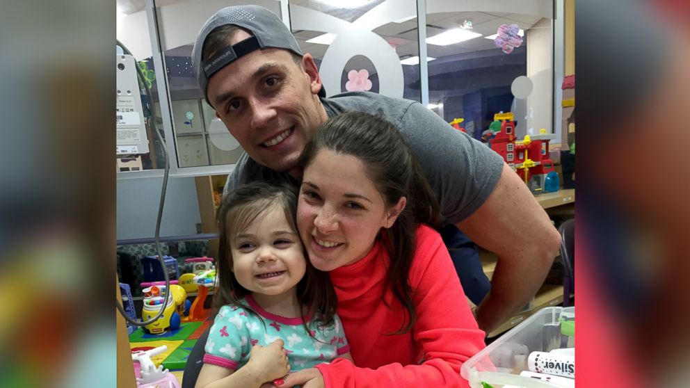 Shelby and Jonathan Skiles pose with their 2-year-old daughter Sophie who was diagnosed with T-cell lymphoma in May.