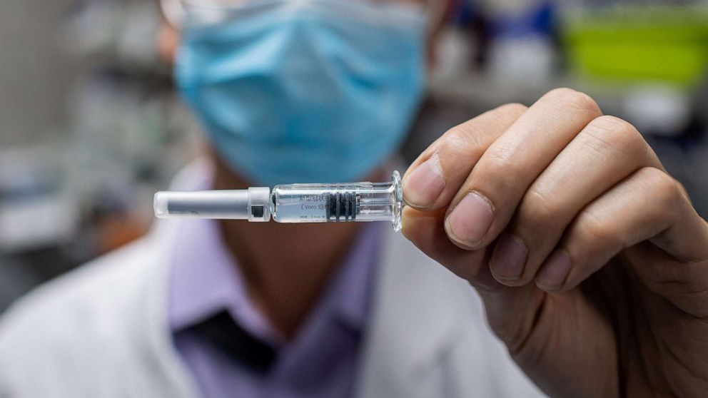 PHOTO: An engineer displays an experimental vaccine for the COVID-19 coronavirus that was tested at the Quality Control Laboratory at the Sinovac Biotech facilities in Beijing, April 29, 2020.