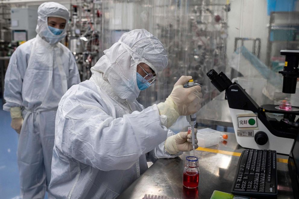 PHOTO: An engineer takes samples of monkey kidney cells as he make tests on an experimental vaccine for the COVID-19 coronavirus inside the Cells Culture Room laboratory at the Sinovac Biotech facilities in Beijing, April 29, 2020.