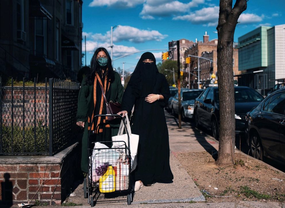 PHOTO: Sisters Shahana Hanif (left) and Sabia Hanif, community organizers in Kensington, Brooklyn, in New York City, perform a delivery during the coronavirus pandemic, May 2020.