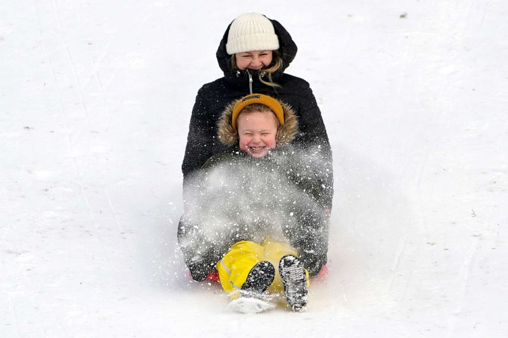 PHOTO: People sled down a city park hill after a recent snowfall, Dec. 27, 2021, in Bellingham, Wash.