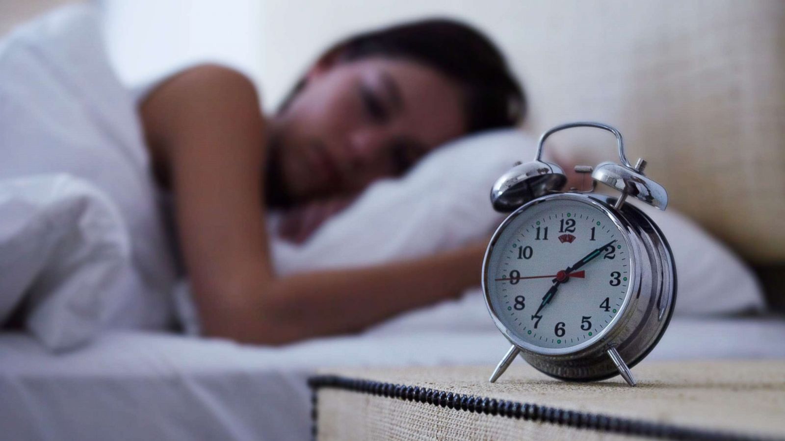 PHOTO: A young woman sleeps with an alarm clock next to her bed in this undated stock photo.