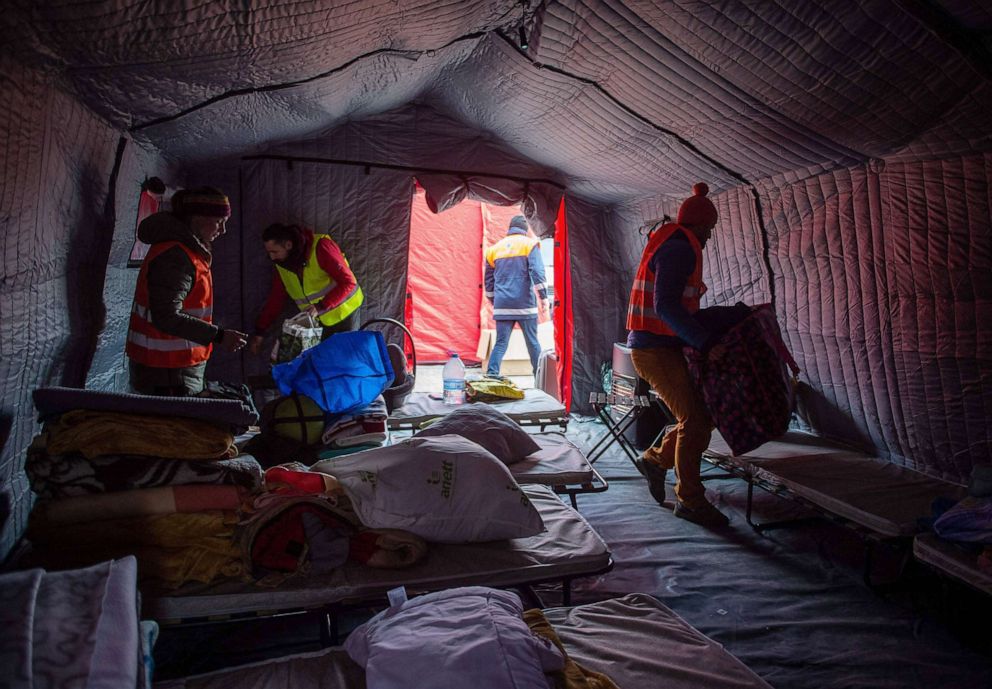 PHOTO: Volunteers set up beds in a camp set up near the Slovak-Ukrainian border crossing in Vysne Nemecke, eastern Slovakia, March 1, 2022.