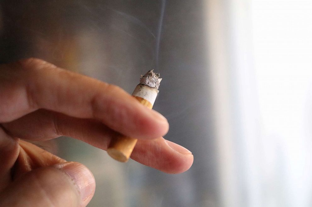 PHOTO: A closeup of a hand holding a cigarette.