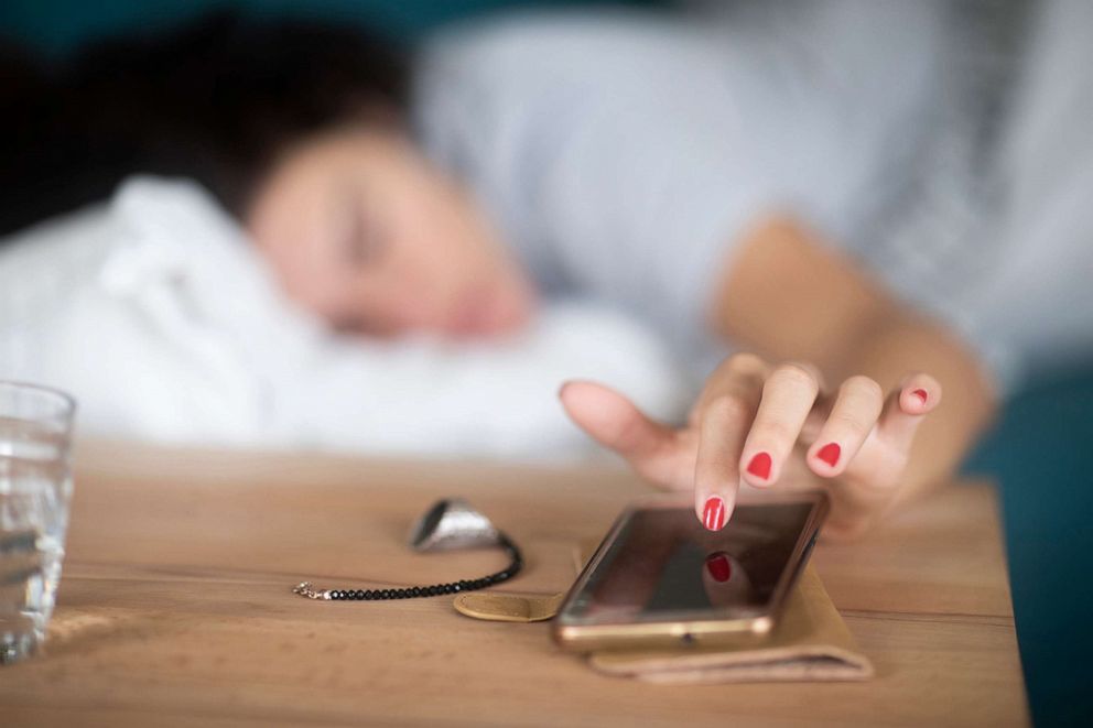 PHOTO: A person hits the snooze button on an alarm on their smartphone in an undated stock photo.