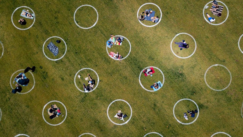 PHOTO: An aerial view shows painted circles in the grass to encourage people to social distance at Washington Square Park in San Francisco, May 22, 2020, amid the novel coronavirus pandemic.