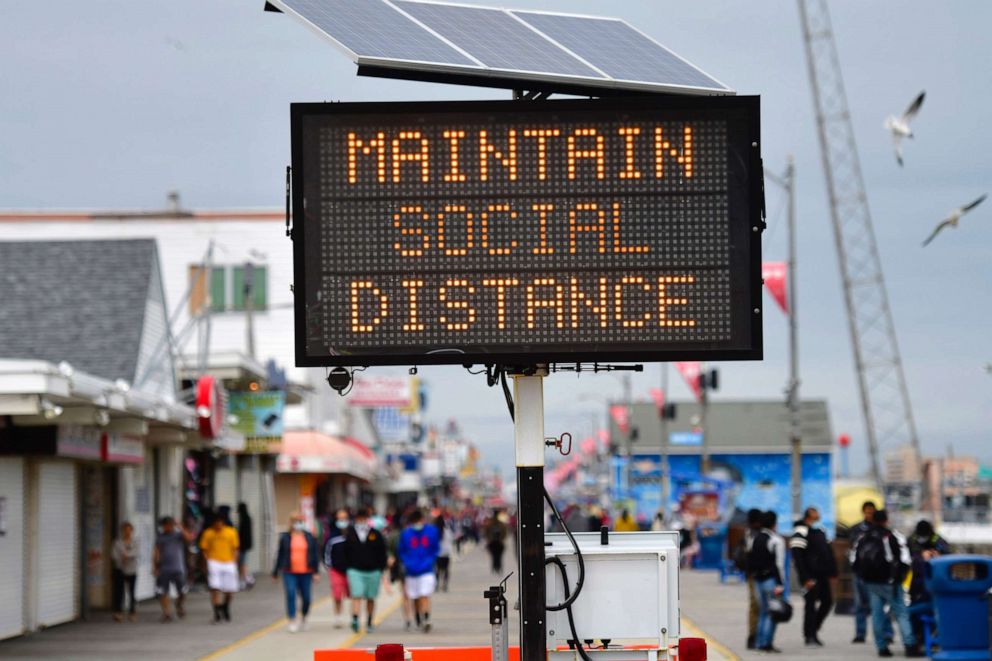 PHOTO: A sign placed on the boardwalk states "MAINTAIN SOCIAL DISTANCE," May 24, 2020, in Wildwood, New Jersey.