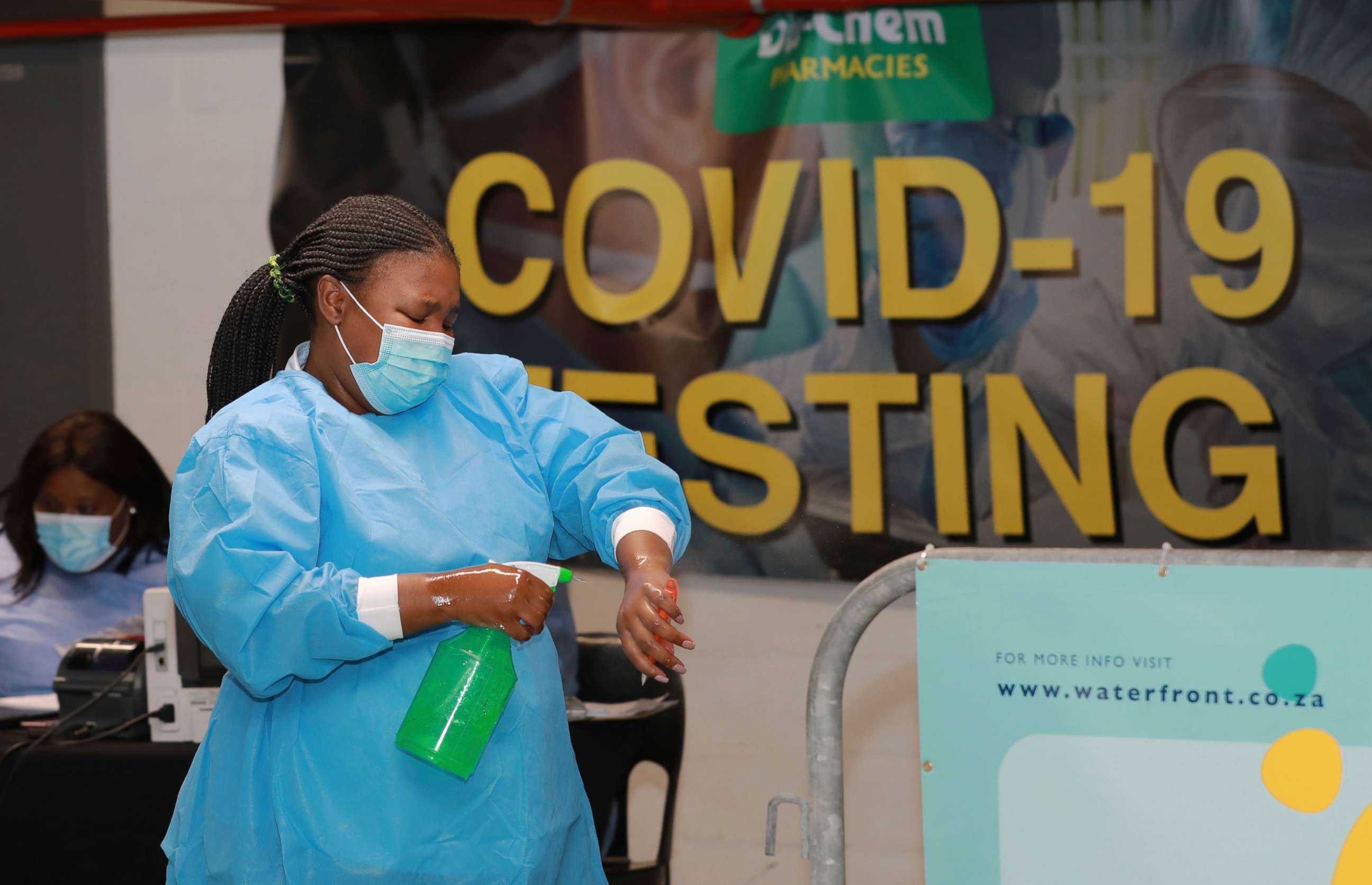 PHOTO: A health-care worker sanitizes her hands before conducting COVID-19 tests at a Dis-Chem drive-through testing station at the V&A Waterfront in Cape Town, South Africa, Jan. 8, 2021.