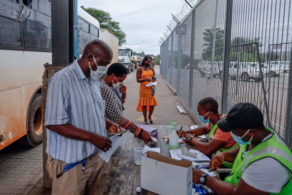PHOTO: Travelers get their COVID-19 PCR test results checked at the South African side of the Beitbridge border between South Africa and Zimbabwe near Musina, on Jan. 8, 2021.