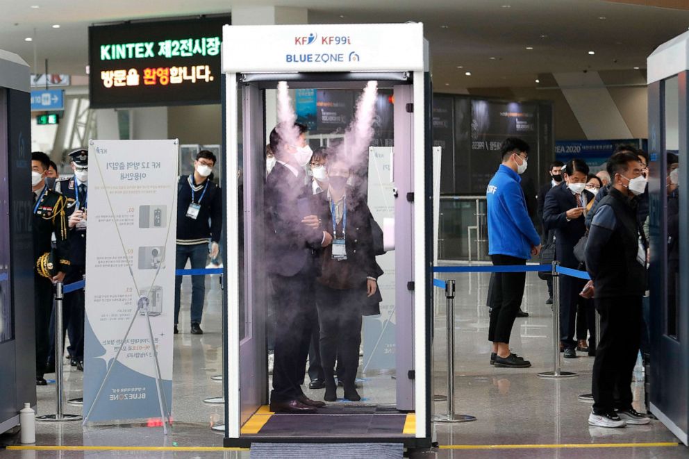 PHOTO: An attendee stands in a sterilizer station as a precaution against the coronavirus, before entering the DX Korea 2020 defense expo in Goyang, South Korea, Nov. 18, 2020.