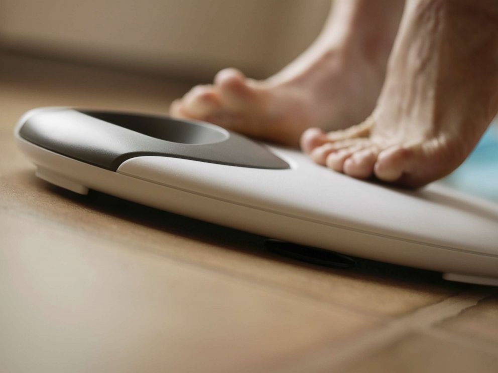 PHOTO: A person stands on a scale in this undated stock photo.