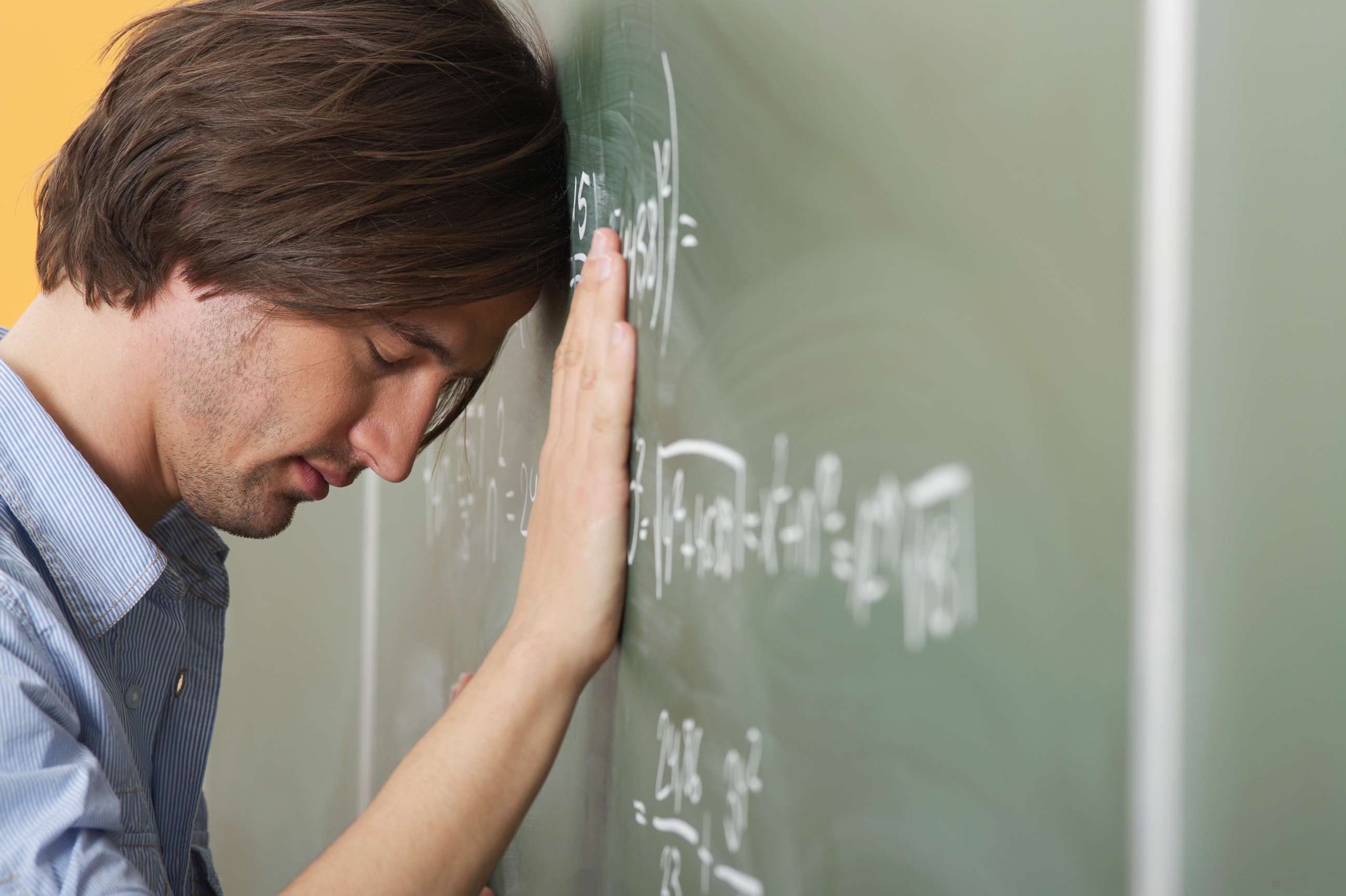 PHOTO: A college student is pictured leaning his head against a blackboard in this undated stock photo