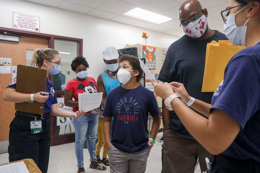 PHOTO: Students and their families fill out paperwork at a back to school health clinic at Middleton High School in Tampa, Fla., on July 31, 2021.