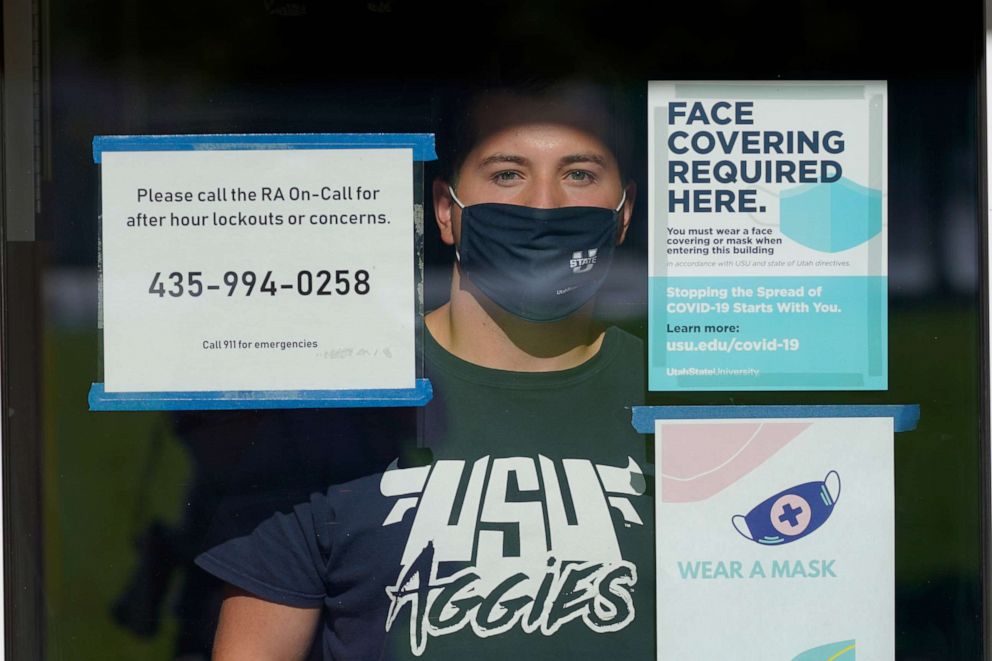 PHOTO: Ryan Schmutz looks from his dorm at Utah State University Wednesday, Sept. 2, 2020, in Logan, Utah, where he was one of about 300 students quarantined to their rooms this week.