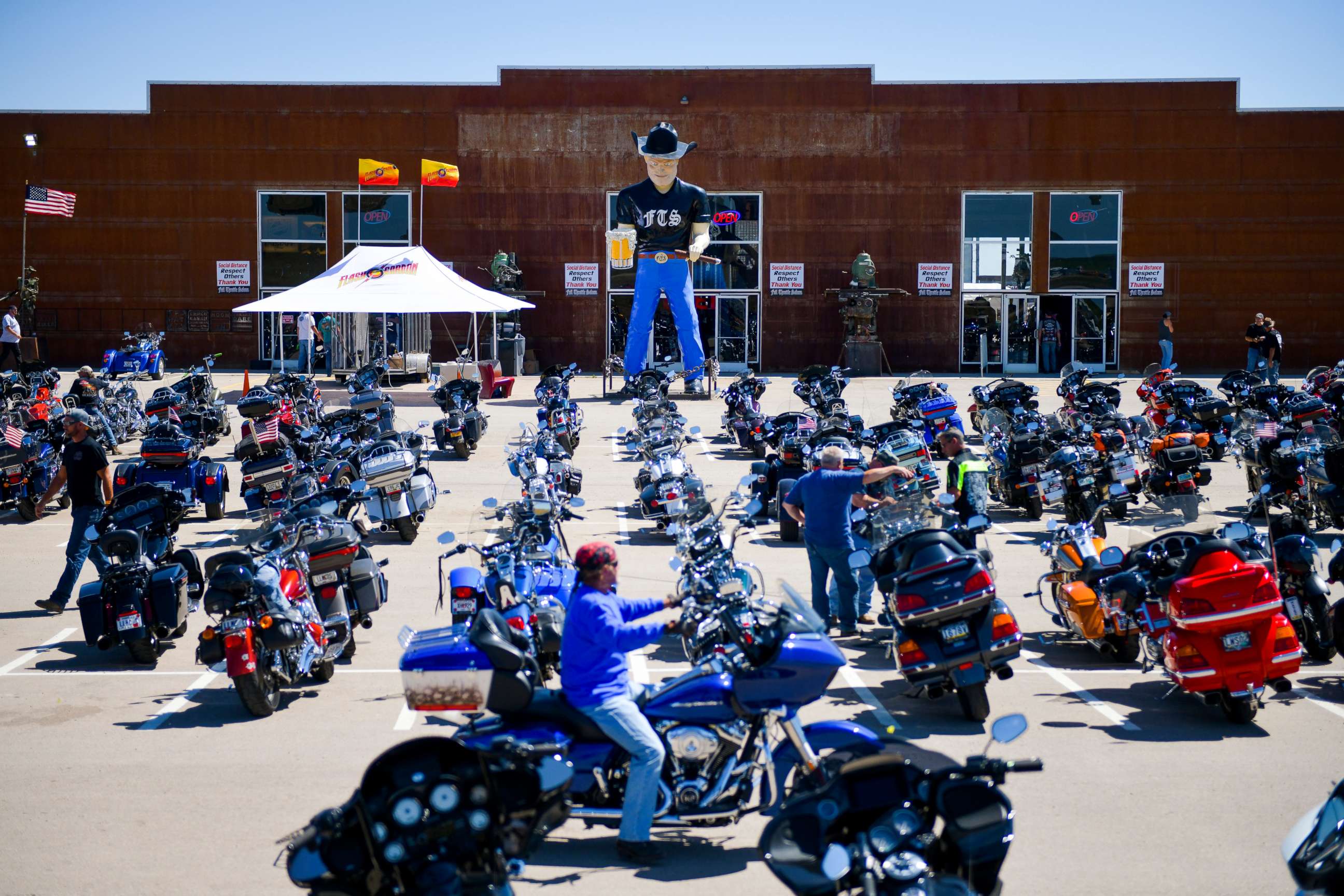 PHOTO: A motorcycle rider looks for parking outside the Full Throttle Saloon during the 80th Annual Sturgis Motorcycle Rally in Sturgis, South Dakota, Aug. 9, 2020.