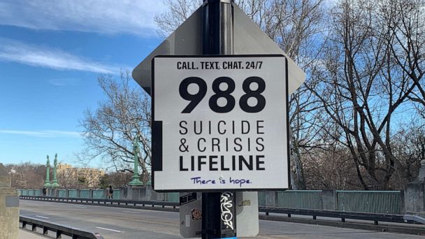 A 988 Suicide & Crisis Lifeline sign at the entrance to Taft Bridge in Washington is photographed on Feb. 10, 2023.