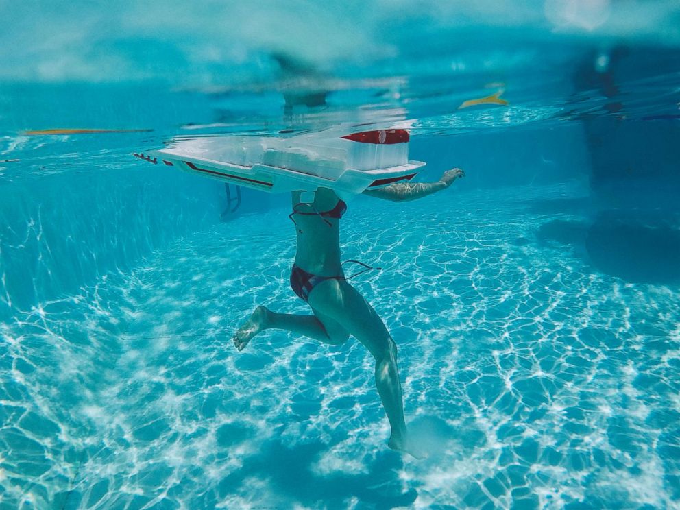 PHOTO: A swimmer in the water at a pool.