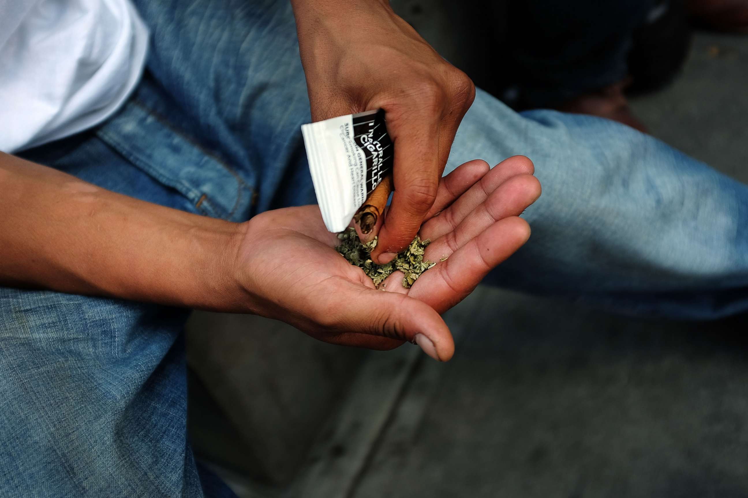 PHOTO: A man prepares to smoke K2 or "Spice", a synthetic marijuana drug, in East Harlem, Aug. 5, 2015 in New York City.