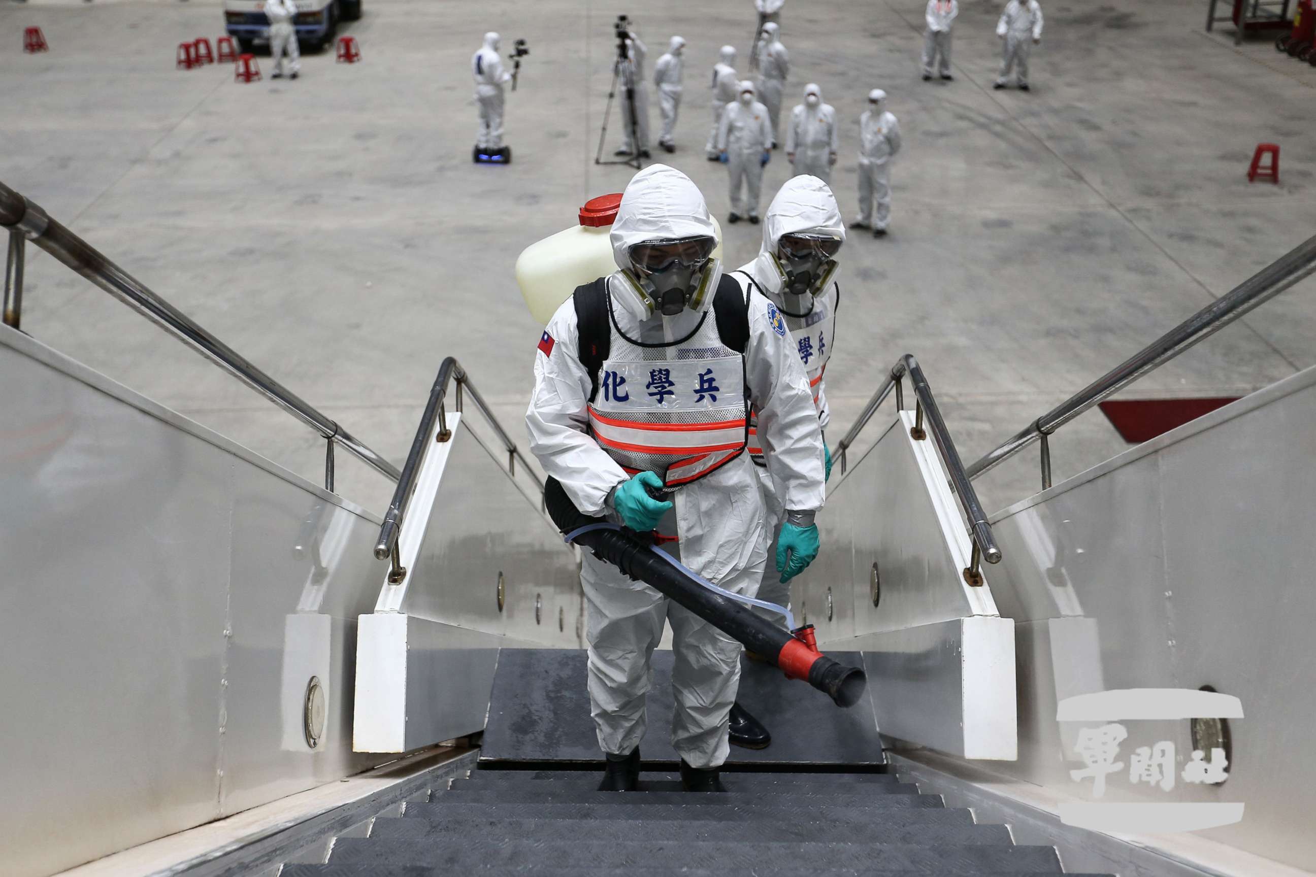 PHOTO: A photo made available by the Ministry of National Defense shows soldiers in protective suits disinfecting the boarding ladder after a China Eastern Airlines plane landed at Taoyuan International Airport in Taoyuan City, Taiwan, March 11, 2020. 