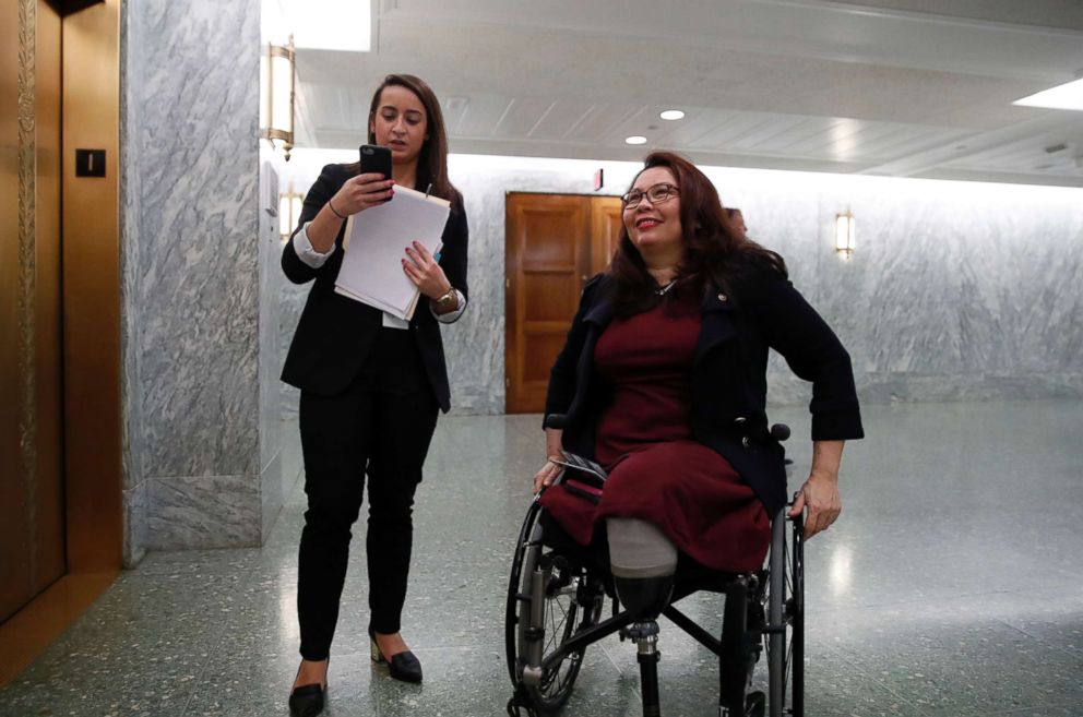 PHOTO: Sen. Tammy Duckworth, D-Ill., right, waits with an aide for the elevator on Capitol Hill, Feb. 14, 2018 in Washington.