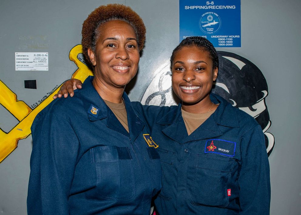 PHOTO: Master Chief Logistics Specialist Tonya McCray poses for a photo with her daughter, Logistic Specialist Seaman Racquel McCray, while they both serve aboard the USS Gerald R. Ford, July 17, 2021.