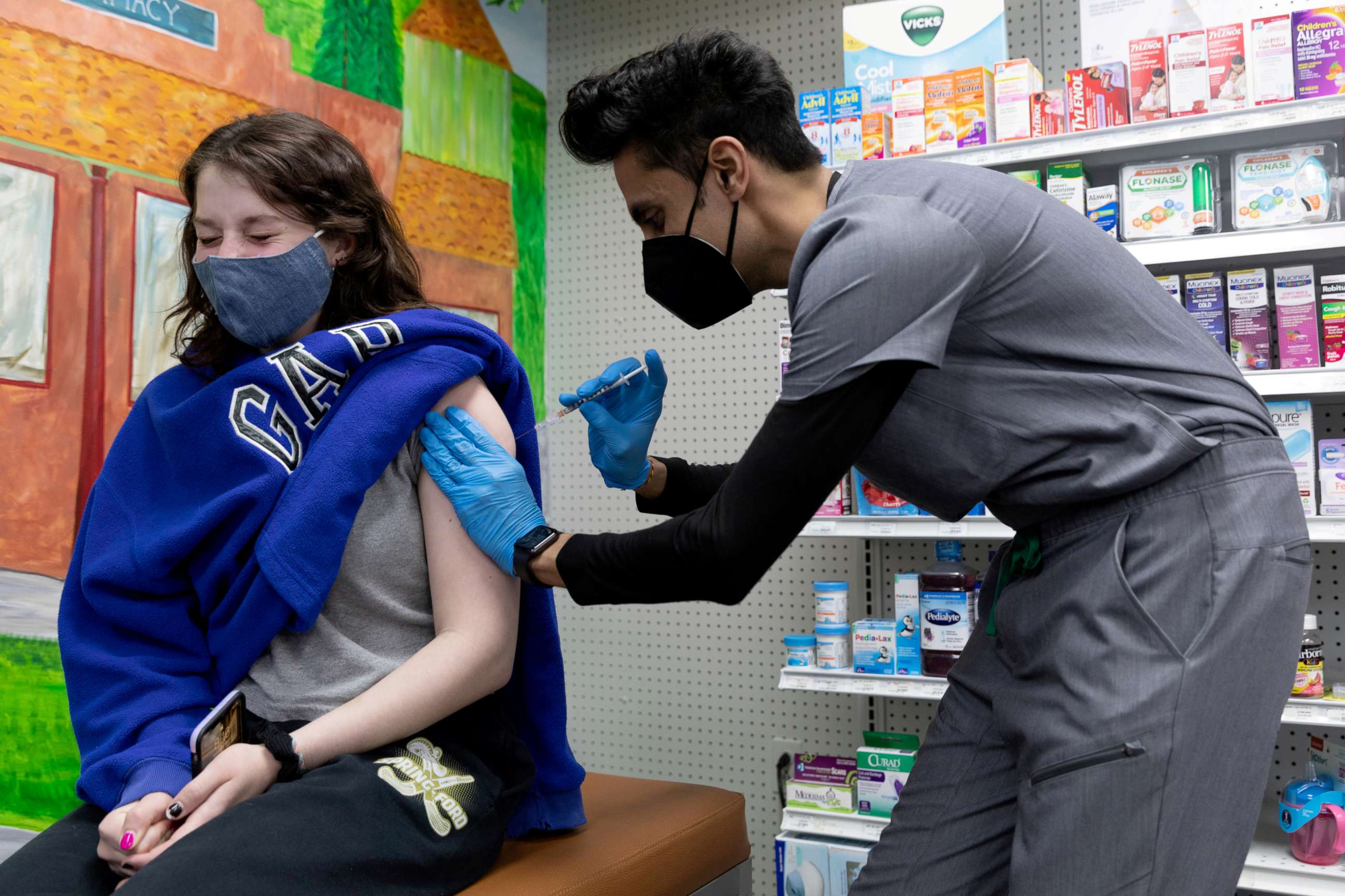 PHOTO: Julia Gadsby, 18, who has Lupus, receives the Pfizer-BioNTech vaccine against the coronavirus disease (COVID-19) at Skippack Pharmacy in Schwenksville, Pennsylvania, March 3, 2021.