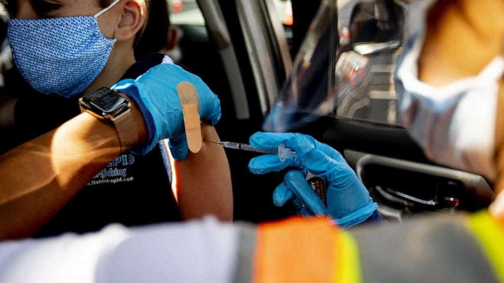 PHOTO: A healthcare worker administers a dose of the Pfizer-BioNTech COVID-19 vaccine to a teenager at a drive-through clinic at California State University, Northridge (CSUN) in Northridge, Calif. on May 13, 2021.